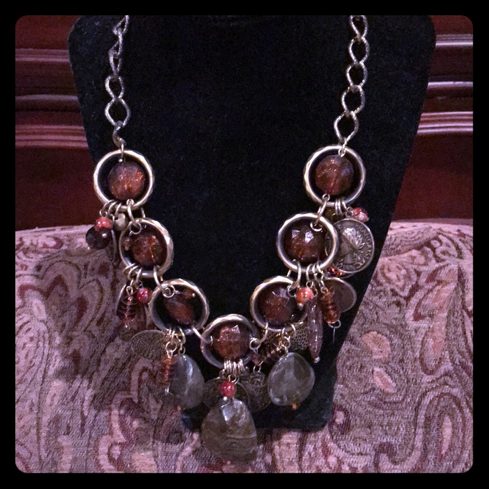 Stones and coins on brushed brass chain